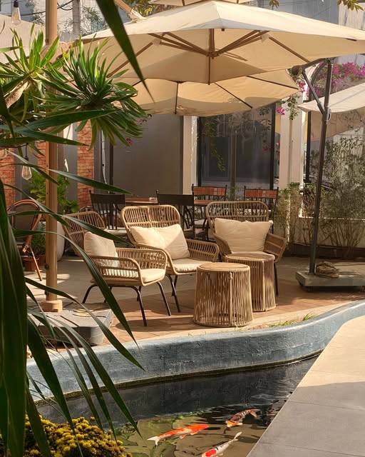 Garden terrace with rattan chairs by the koi pond